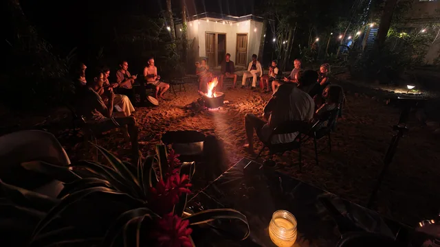 People gathered around a fire after dark