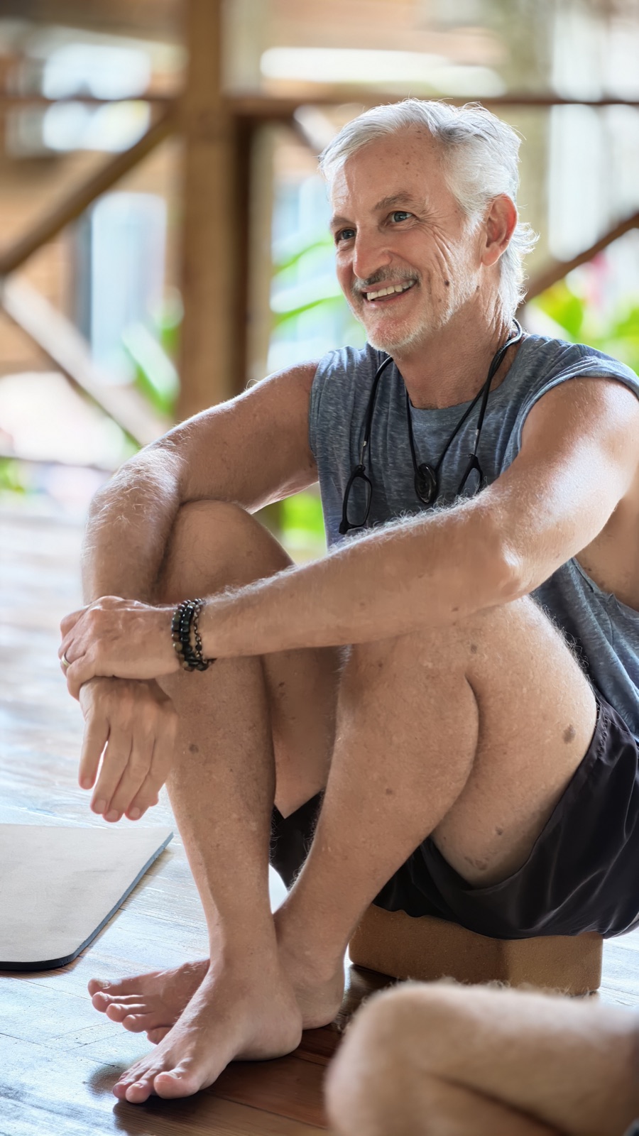 Garlon smiling while seated in the retreat pavilion