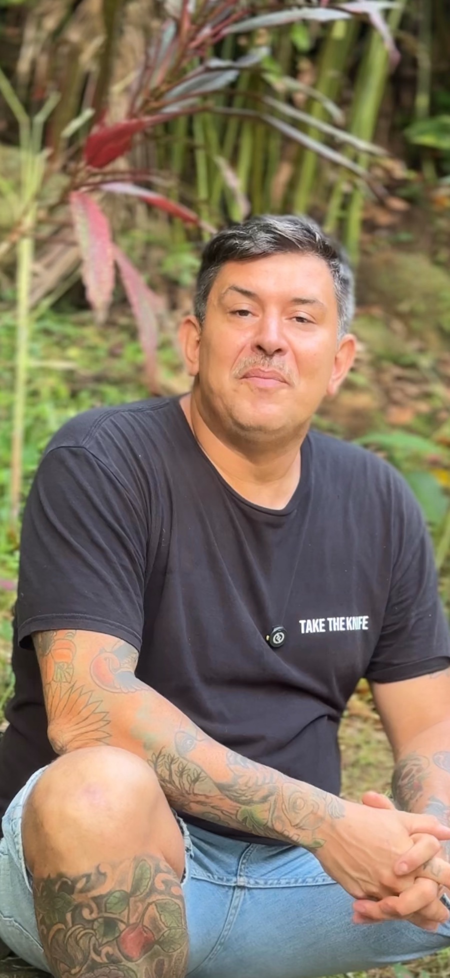 German Sozzi seated outdoors among tropical plants